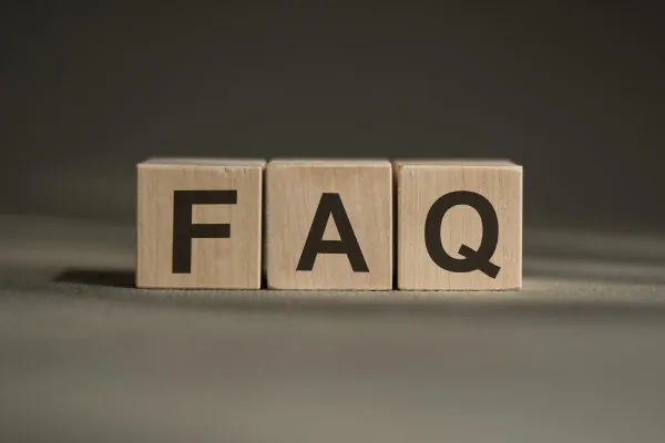Word faq made with wood building blocks on a gray background